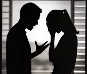 Silhouette of a man and woman having an argument at home.