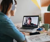 Young woman teleconferencing with sister on laptop on conference call