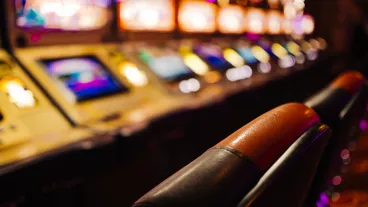 Blurry image of pokies machines inside a casino.